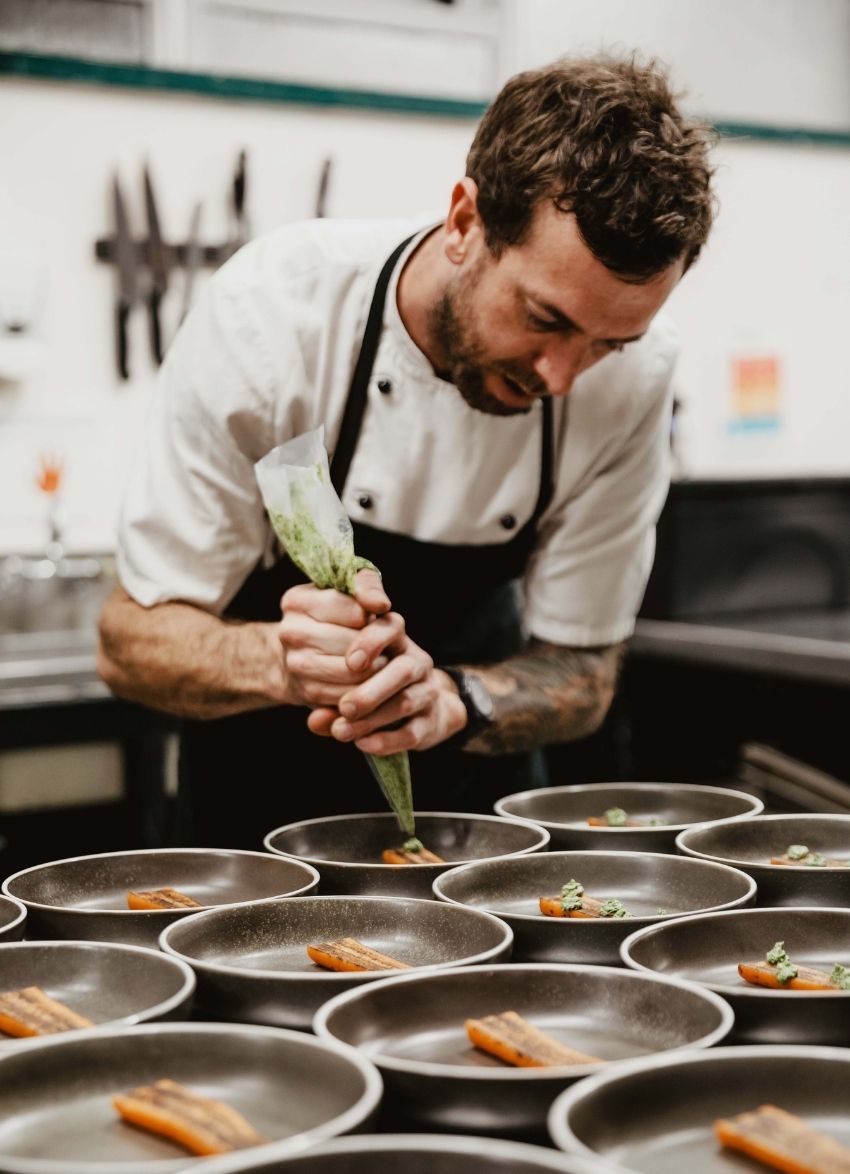 Chef garnishing dish
