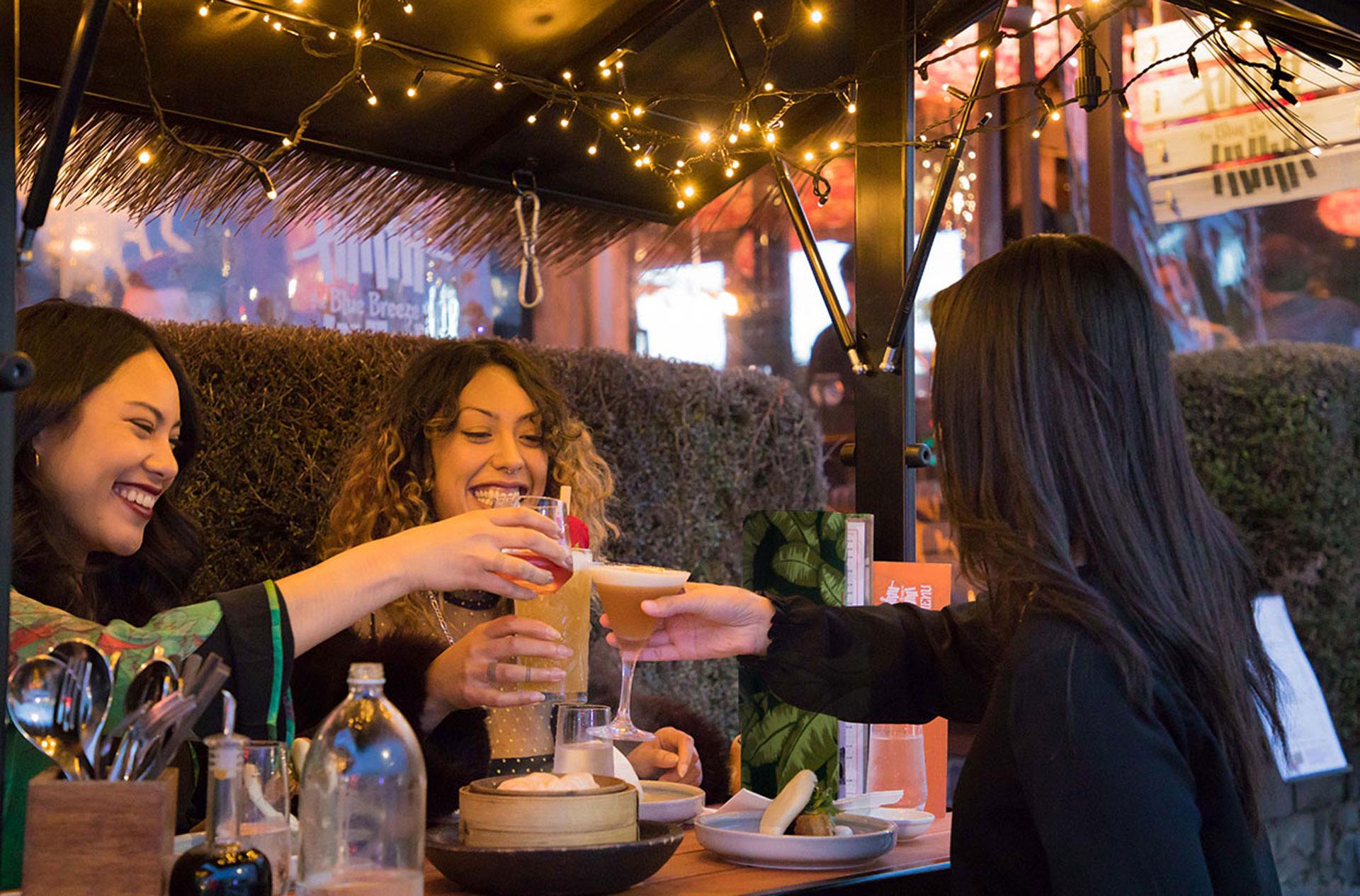 Friends enjoying food and drinks in Ponsonby